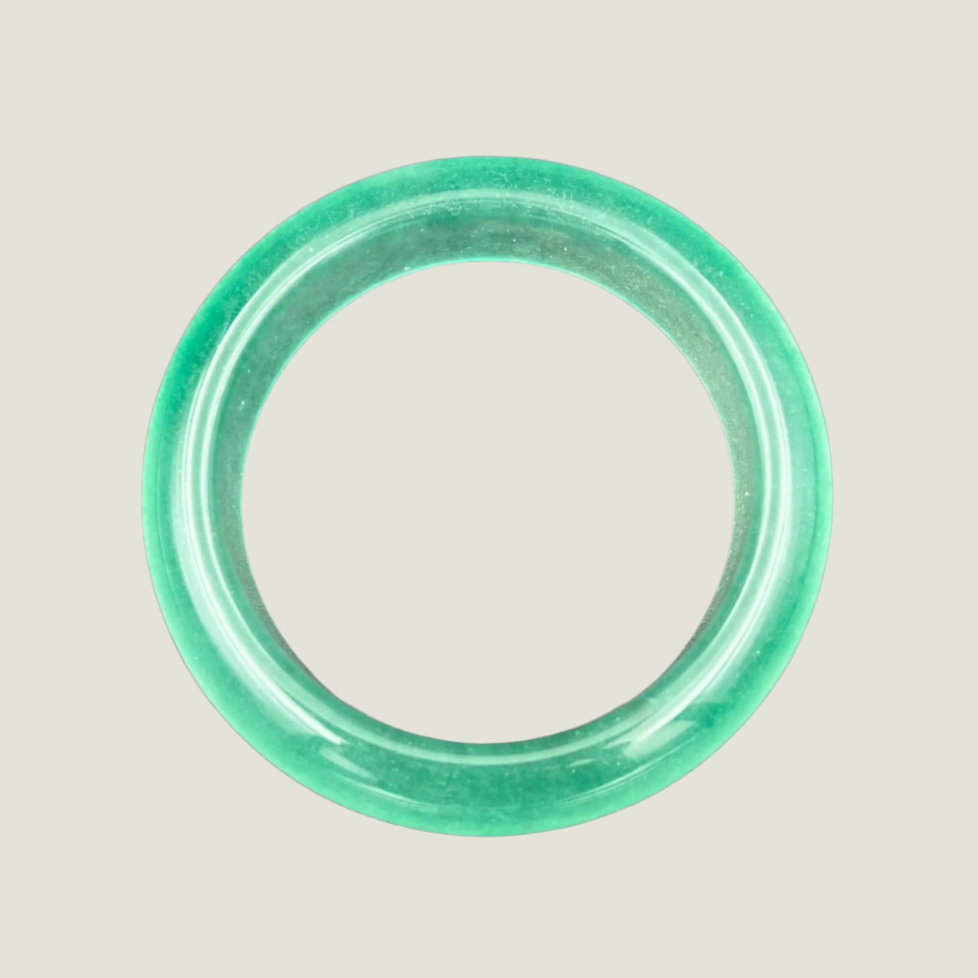 Green jade bracelet on a gray background