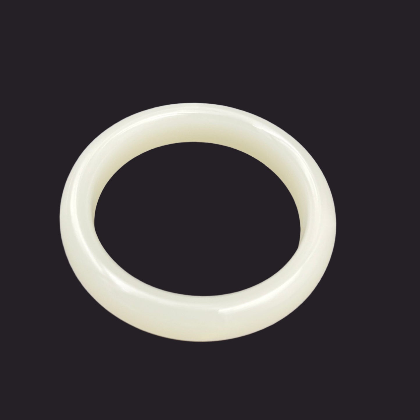 White jade bracelet on a gray background