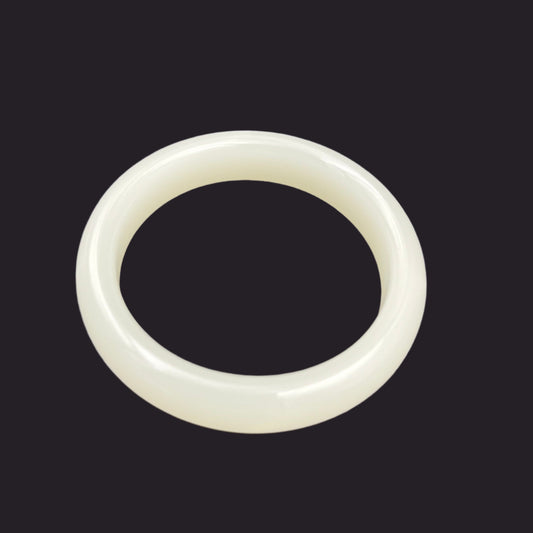 White jade bracelet on a gray background
